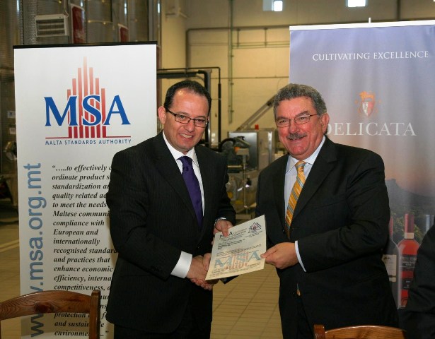 Mr George Delicata (right) collecting the ISO certificate.